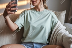 Woman holding phone taking selfie wearing t shirt image Product Image 1