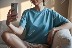 Woman holding phone taking selfie couch casual Product Image 1