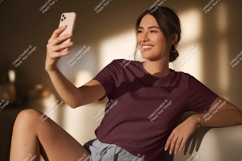 Woman taking selfie with phone maroon t-shirt Product Image 1