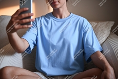 Person holding phone wearing light blue shirt image Product Image 1