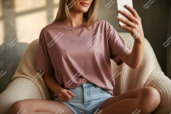Woman taking selfie wearing pink shirt and denim shorts Product Image 1