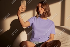 Woman taking selfie in lavender t shirt phone Product Image 1