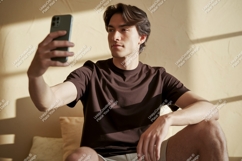 Young man taking selfie with phone casual Product Image 1