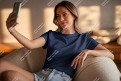 Woman wearing navy blue t shirt taking selfie image Product Image 1