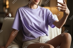 Woman wearing lavender t shirt and shorts taking selfie Product Image 1