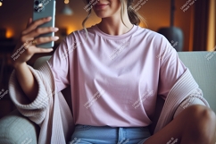 Pink shirt denim shorts woman holding phone image Product Image 1