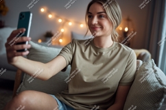 Woman taking selfie with phone casual home Product Image 1