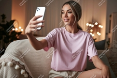 Woman taking selfie with phone on couch pink Product Image 1