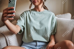 Woman wearing green t shirt taking selfie image Product Image 1