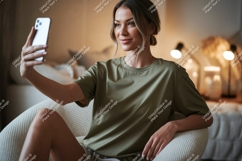 Woman taking selfie in armchair phone casual Product Image 1