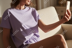 Woman taking selfie on sofa phone casual Product Image 1