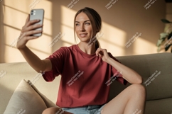 Woman taking selfie on couch phone casual Product Image 1