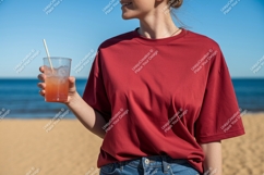 Woman holding drink on beach sand Product Image 1