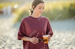 Woman holding drink sunglasses beach sand Product Image 1