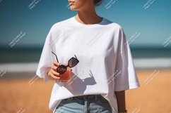 Woman holding drink sunglasses beach white t-shirt Product Image 1