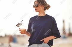 Woman holding drink and sunglasses navy blue Product Image 1