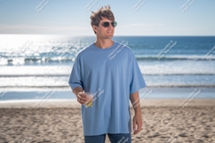 Man wearing blue t shirt holding drink on beach image Product Image 1