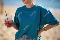 Teal shirt woman holding drink beach Product Image 1