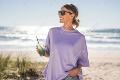 Woman holding green drink on beach sunglasses Product Image 1
