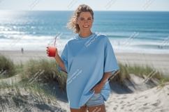 Woman holding drink on beach blue t-shirt Product Image 1