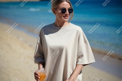 Woman wearing beige t shirt holding orange drink image Product Image 1