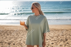 Woman holding drink on beach ocean sand Product Image 1