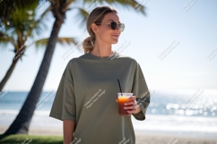 Woman holding drink near ocean beach palm Product Image 1