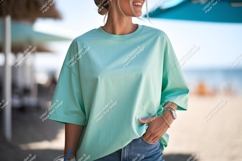 Woman wearing teal t shirt and denim image Product Image 1