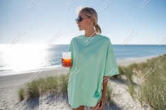Woman wearing oversized shirt holding drink on beach Product Image 1