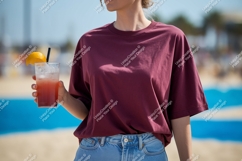 Woman holding refreshing drink on beach maroon t-shirt Product Image 1
