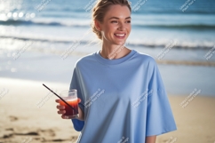 Woman holding drink on beach blue Product Image 1