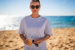 Woman holding drink sunglasses beach sand ocean Product Image 1