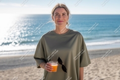Woman holding drink on beach ocean sand Product Image 1
