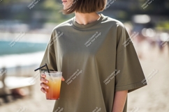 Woman holding orange drink on beach summer casual Product Image 1