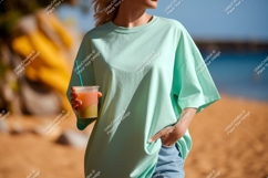 Mint shirt woman holding drink beach image Product Image 1