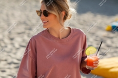 Woman holding pink drink on beach sunglasses Product Image 1