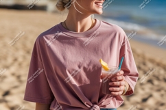 Woman pink shirt holding drink beach image Product Image 1