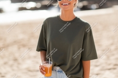 Woman wearing olive green t shirt holding drink image Product Image 1