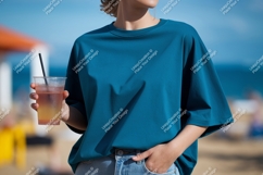 Teal shirt holding drink beach straw Product Image 1