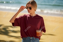 Woman wearing sunglasses and holding drink on beach Product Image 1