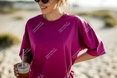 Woman wearing magenta t shirt holding drink image Product Image 1