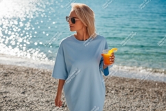 Blonde woman holding orange drink at beach sunglasses Product Image 1