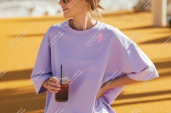 Woman wearing lavender t shirt holding iced coffee Product Image 1