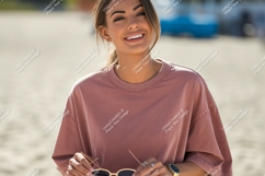 Smiling woman wearing pink shirt sunglasses Product Image 1