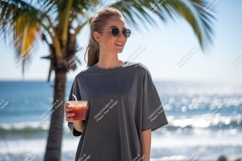 Woman holding drink near palm tree ocean image Product Image 1