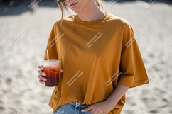 Woman holding drink wearing mustard shirt image Product Image 1