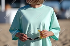 Mint shirt person holding drink sunglasses image Product Image 1