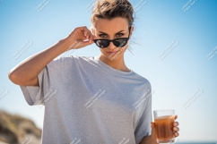 Woman sunglasses holding drink blue sky shirt Product Image 1