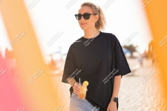 Woman black t shirt sunglasses holding drink image Product Image 1