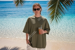 Man wearing olive green t shirt holding drink image Product Image 1